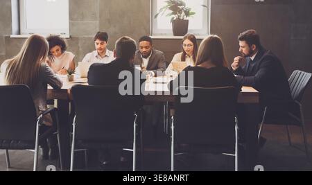 Business team at meeting, discussing project plans Stock Photo