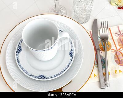 Elegant easter table setting with white porcelain cup and festive napkin Stock Photo