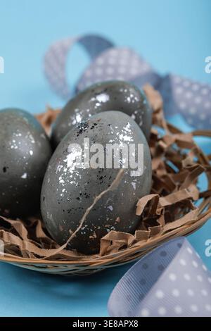 Easter holiday decoration eggs in nest with ribbon Stock Photo