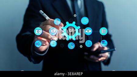 A business executive interacts with a virtual AI ecosystem using a smartphone and stylus, highlighting automation, cloud services, robotics, analytics Stock Photo