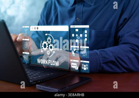 Hands operating a laptop with a virtual workflow interface, showing business process automation, task orchestration, system integration, and digital o Stock Photo