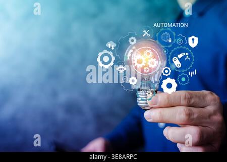 Hand holding a glowing light bulb with automation icons, gears, AI, and robotics, representing smart industrial processes, digital innovation, product Stock Photo