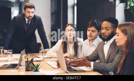Team meeting process. Colleagues discussing new project Stock Photo