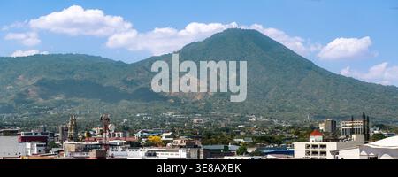San Salvador cityscape and San Salvador volcano in the background showing urban landscape and mountains under blue sky Stock Photo