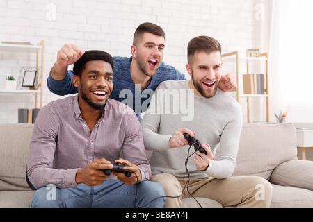 Gamers. Happy men playing video games at home Stock Photo
