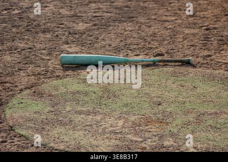 Baseball bat on the field Stock Photo