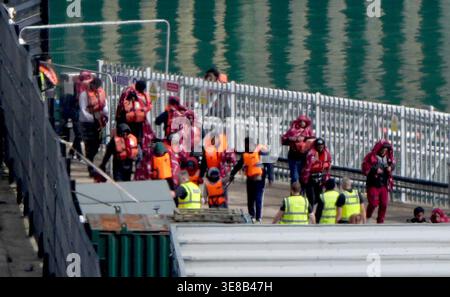 A group of people thought to be migrants are brought in to the Border ...