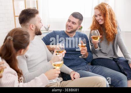 Celebrate meeting. Friends drinking wine and talking Stock Photo
