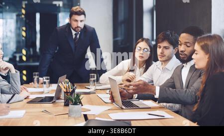 Business team using laptop, check results of their work Stock Photo