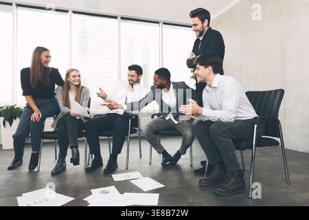 Teamwork and brainstorming. Colleagues discussing blueprints in office Stock Photo