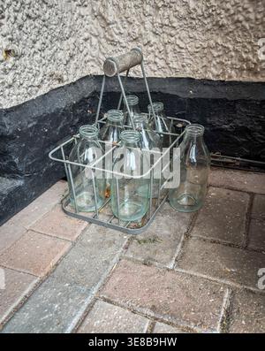12 APRIL 2026 - Cambridge, UK - Empty Milk bottles on the doorstep waitign for the milk man daily delivery of farm fresh milk. Stock Photo