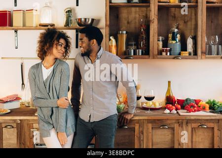 Lovely black couple standing in cozy kitchen Stock Photo