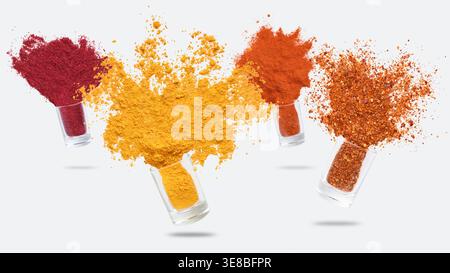 Glass jars with various spices flying on white background Stock Photo