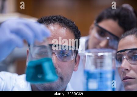 Medical team of doctors and laboratory technicians analyzing blood samples in clinical research lab Stock Photo