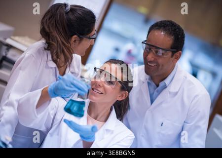Middle Eastern medical team of young doctors and technician collaborating in blood testing lab Stock Photo
