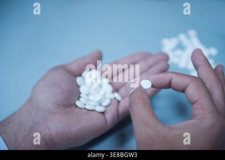 Young Middle Eastern and Arab medical technicians and doctors handling medicine and blood testing samples in lab Stock Photo