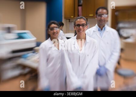 Medical team of doctors and lab technicians working together in a blood testing laboratory Stock Photo