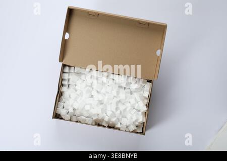 Cardboard box with styrofoam cubes isolated on white, top view Stock Photo