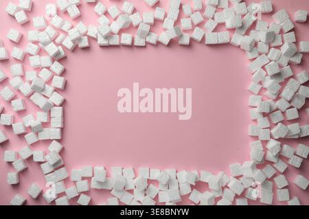 Frame made of styrofoam cubes on pink background, flat lay. Space for text Stock Photo