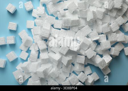 Many styrofoam cubes on light blue background, flat lay Stock Photo