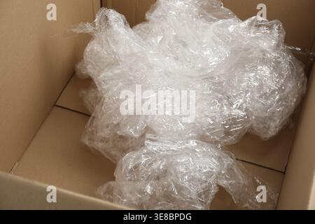 Crumpled plastic film in cardboard box, closeup Stock Photo