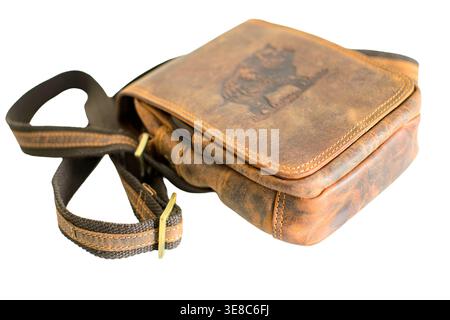 Vintage brown leather shoulder bag with embossed wild boar motif, hunter style crossbody messenger bag on white background. Stock Photo