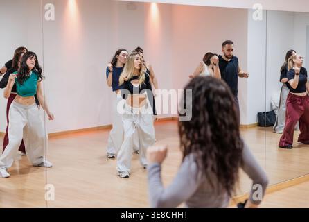 Diverse group of people practicing urban dance choreography in studio Stock Photo