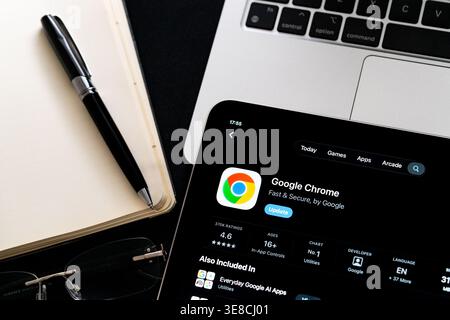 Google Chrome logo on iPad in Apple Liquid Glass iOS 26 interface photographed on desk with pen and laptop. Stafford, United Kingdom, April 13, 2026. Stock Photo