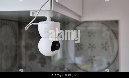 White smart security camera mounted indoors Stock Photo