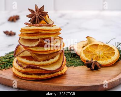 Background for personalized Christmas card. Tree decor of dehydrated dried orange and apple slices with star anise. Fall, Christmas, Thanksgiving Stock Photo