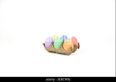 Easter basket stuffer of cardboard egg tray holding six brightly colored chalk Easter eggs Stock Photo