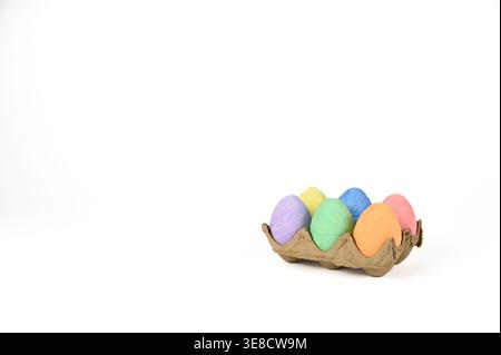 Easter basket stuffer of cardboard egg tray holding six brightly colored chalk Easter eggs Stock Photo