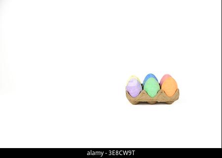Easter basket stuffer of cardboard egg tray holding six brightly colored chalk Easter eggs Stock Photo