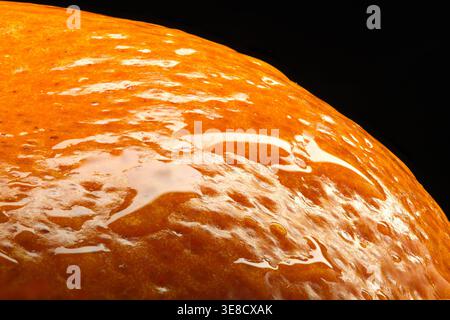 Curved Tangerine Segment Macro Close-Up on Black Background, Juicy Citrus Texture with Diagonal Composition Stock Photo