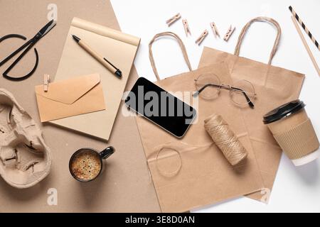 Composition with mobile phone, cup of coffee, packaging items and delivery paper bag on color background Stock Photo
