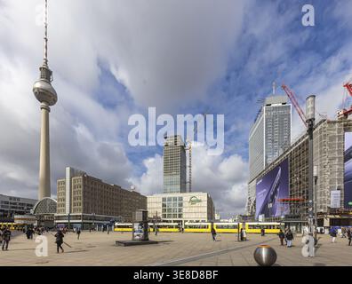 View of Alexanderplatz in Berlin. Covivio Tower and The Berlinian construction sites. Megaposter advertising poster and a tram. TV tower. Berlin, Germ Stock Photo