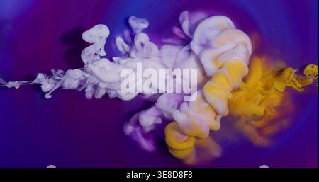 Ink drop. Cloud mix. Blur white yellow purple color mist bright splash vibrant acrylic texture spreading on abstract art background. Stock Photo
