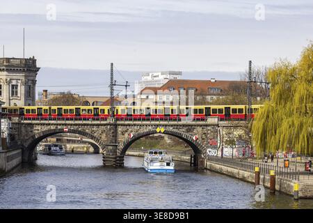 Spree with aerial boat and S-Bahn. View of a railway bridge and the Charite ward. Berlin, Germany Stock Photo