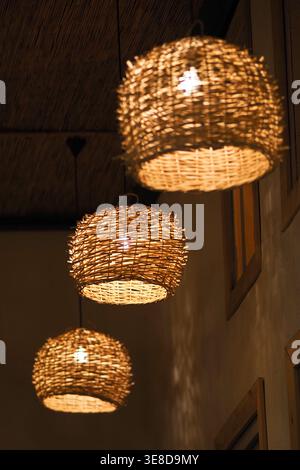Hanging lights made of woven materials in a dark room Stock Photo