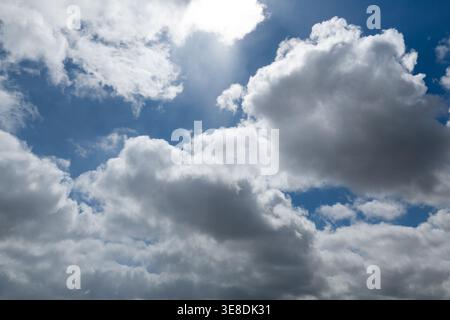Dramatic white clouds on a deep blue sky background Stock Photo