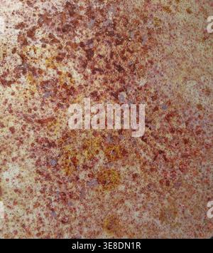 Detailed texture of heavy orange and brown rust spots on a weathered metallic surface Stock Photo