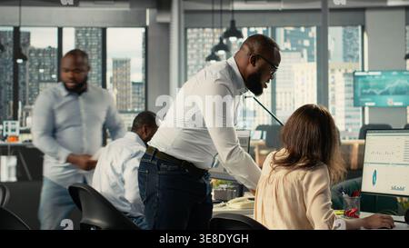 Professional employees and colleagues working together in office. Diverse work team collaborates on project planning, analytics and report writing for corporate development. Stock Photo