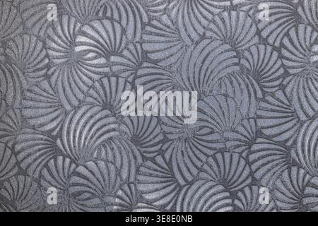 Elegant gray art deco wallpaper featuring a repeating geometric fan pattern with metallic silver accents. Stock Photo