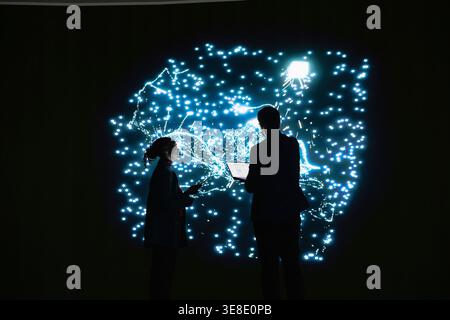 Team of technicians implementing deep learning algorithms for AI system, working together. RD department colleagues talk about artificial intelligence neural network architecture Stock Photo