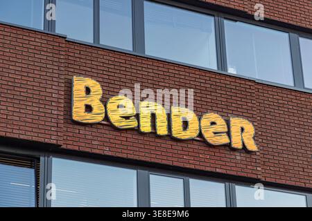 Utrecht, Netherlands, April 1, 2026. Exterior view of the colorful yellow Bender brand logo mounted on a modern red brick office building wall. Stock Photo