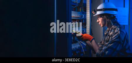 Technical specialist inspecting electrical panel with voltage tester. Modern energy. Stock Photo