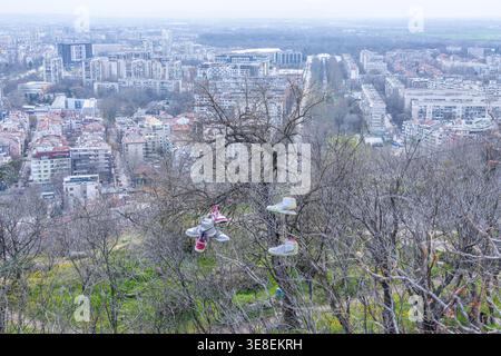 Sneakers hanging on power lines over Plovdiv Old Town Bulgaria.  Stock Photo