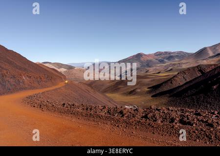 Winding dirt road through colorful mountain valley Stock Photo