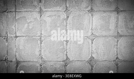 Gray concrete wall texture with square pattern and vignette, rough cement background with industrial detail and copy space Stock Photo
