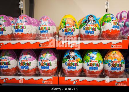 RIGA, LATVIA. 12th March 2026. A retail display featuring several rows of Kinder Surprise Maxi chocolate eggs in colorful foil packaging. The large ch Stock Photo
